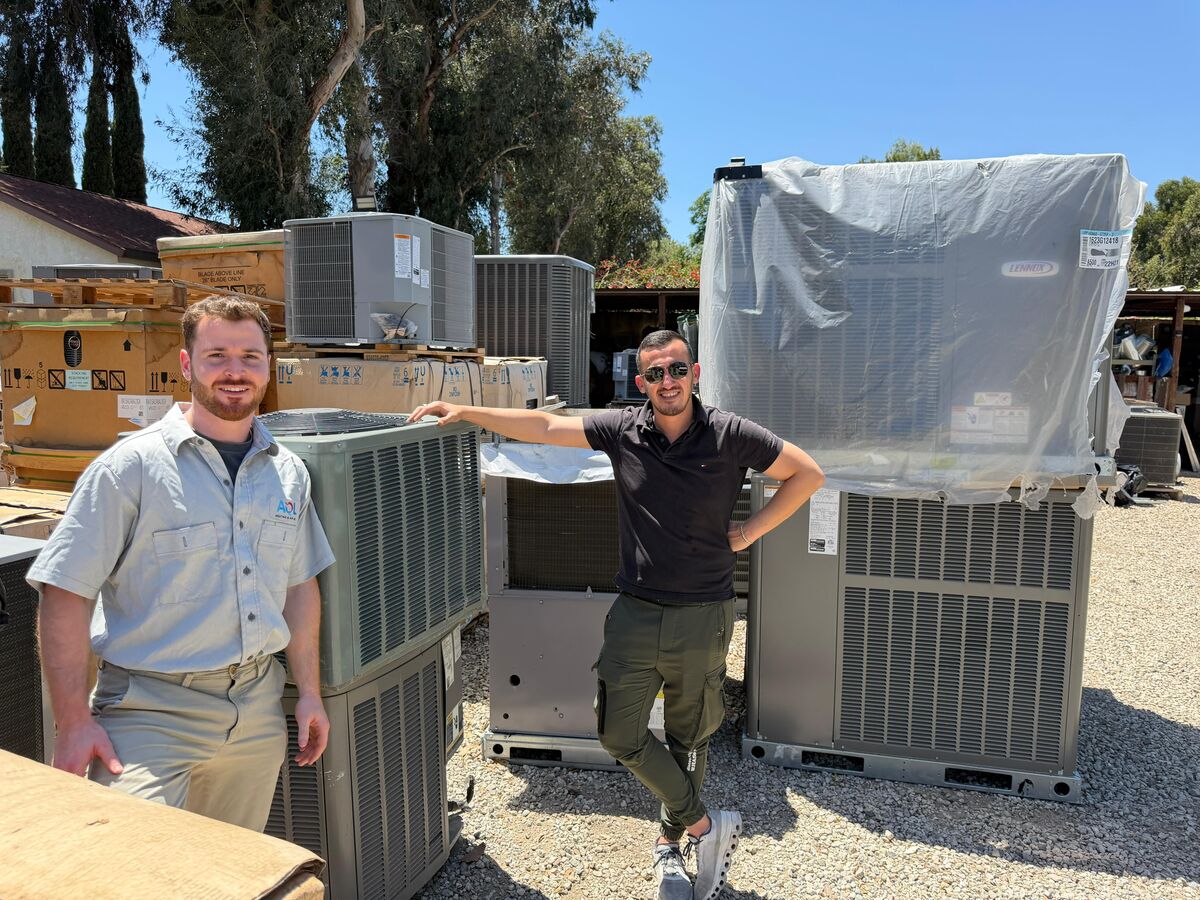 Apex Climate Solutions team with HVAC unit